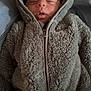 baby, infant, newborn, sleeping, hood, hooded_jacket, fleece, fuzzy, onesie, zipper, closed_eyes, face, mouth, cozy, portrait, indoor, soft_texture, blanket_like, warm, resting