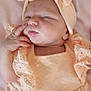 baby, infant, sleeping, peach_outfit, head_wrap, hand, blanket, floral_pattern, soft_fabric, cute, newborn, child, portrait, peaceful, resting, skin, face, close_up, indoors, person