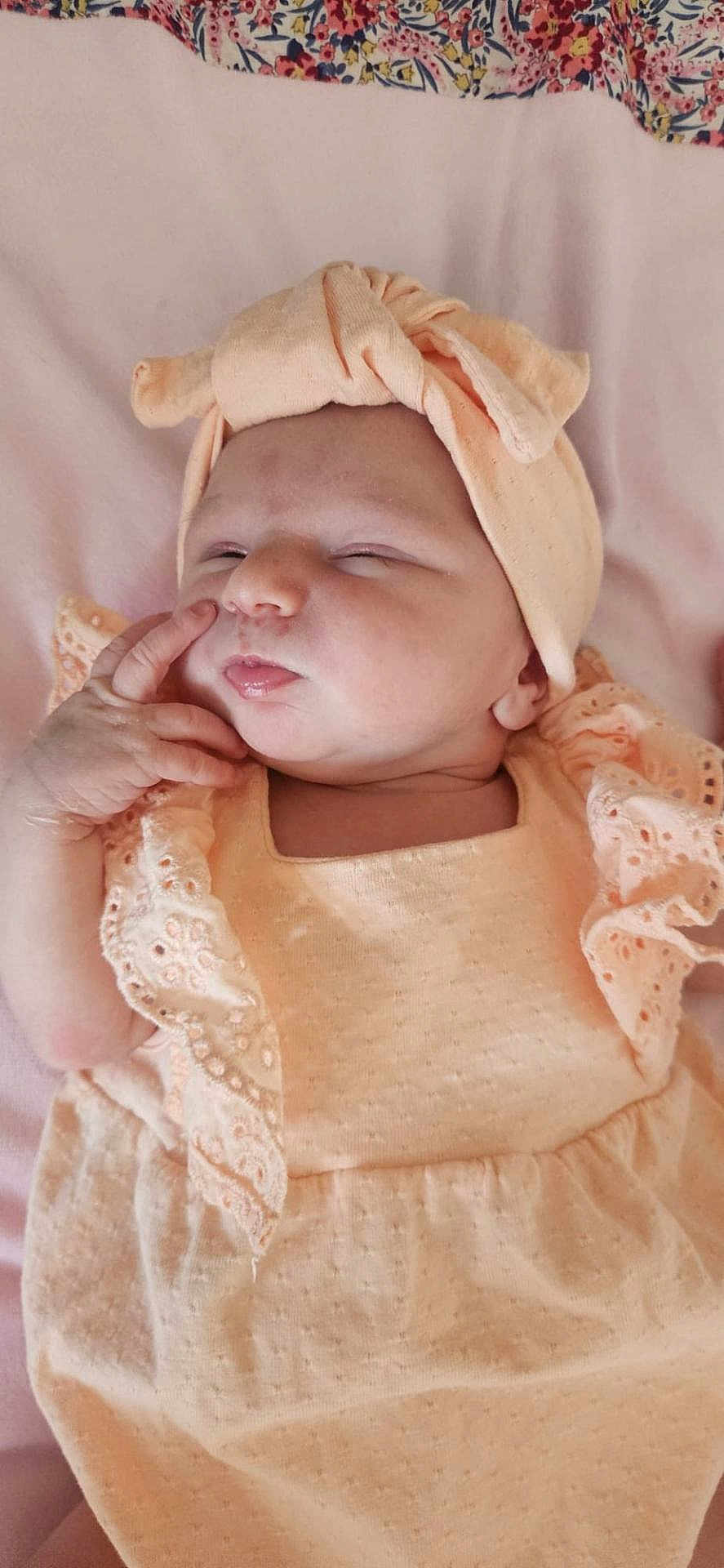 Livia participe au concours pour gagner de l'argent avec cette photo : baby, infant, sleeping, peach_outfit, head_wrap, hand, blanket, floral_pattern, soft_fabric, cute, newborn, child, portrait, peaceful, resting, skin, face, close_up, indoors, person