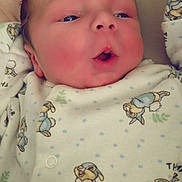 Thomas joined the competition — help win amazing prizes! baby, newborn, infant, face, expression, onesie, clothing, cartoon, animal_print, cute, soft_lighting, closeup, skin, head, small_hands, lying_down, indoors, sleepwear, adorable, child