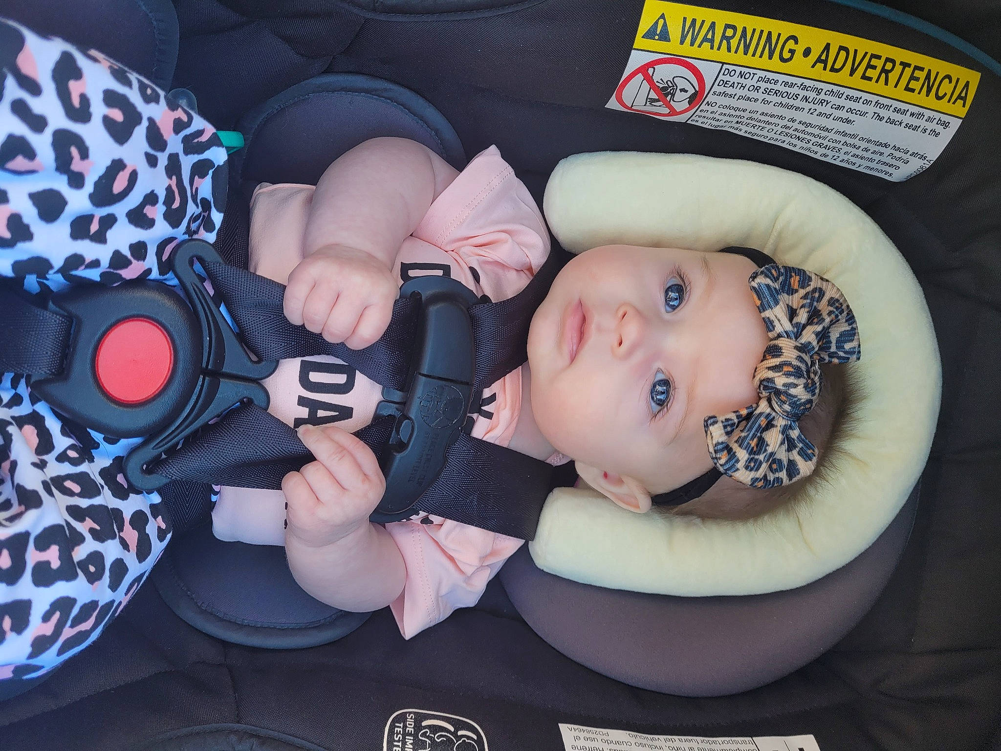 Paisley is registered to the contest to win money with this photo: audio_equipment, auto_part, automotive_wheel_system, baby, baby_carriage, baby_in_car_seat, baby_products, baby_toddler_clothing, car_seat, child, comfort, fashion_accessory, finger, hand, headwear, pattern, person, pink, product, room