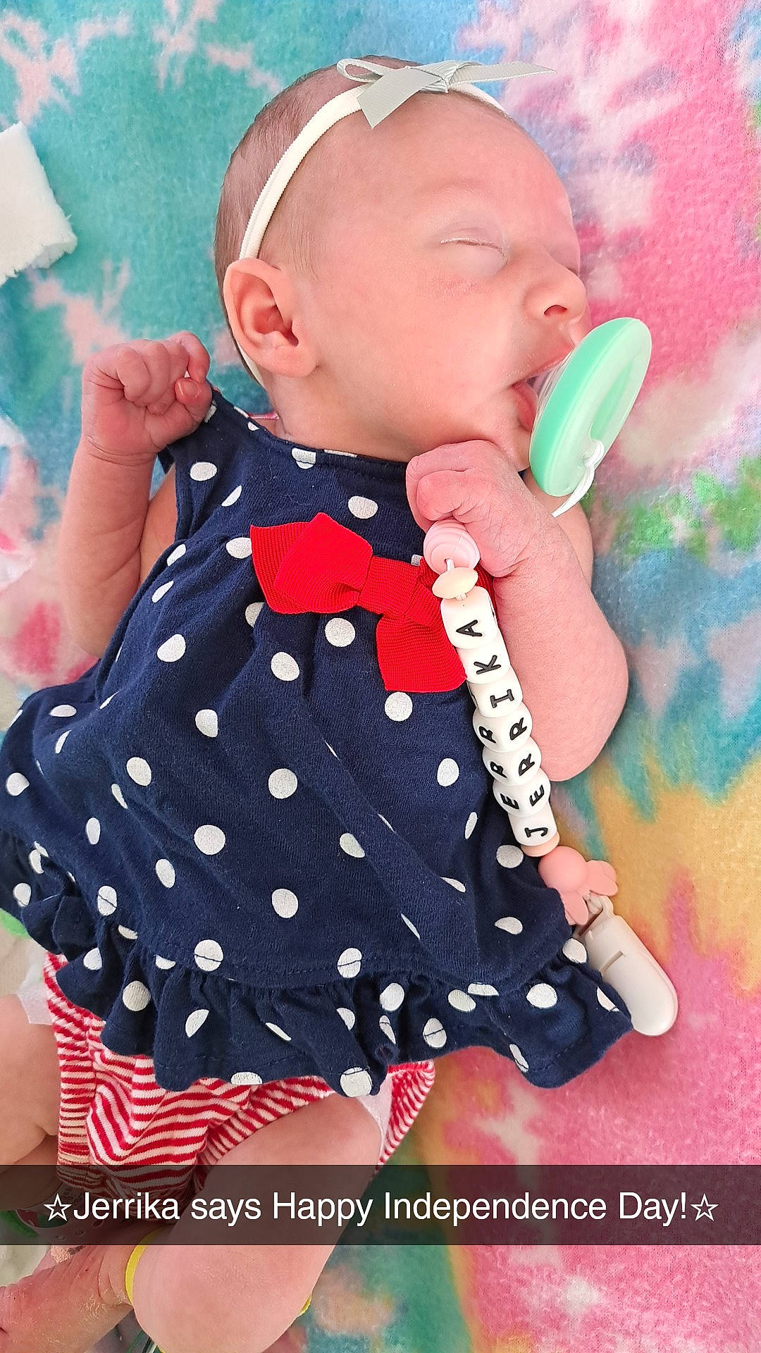 Jerrika is registered to the contest to win money with this photo: baby, baby_toddler_clothing, cap, cheek, child, day_dress, finger, gesture, happy, lip, magenta, nail, one_piece_garment, pattern, person, pink, skin, sleeve, textile, thumb