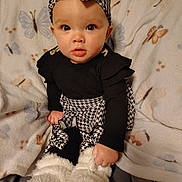 Maci is registered to the contest to win money with this photo: baby, child, infant, black_clothing, houndstooth_pattern, headband, blanket, butterfly_pattern, boots, fur_boots, cute, portrait, sitting, indoors, cozy, wide_eyes, curious, fashion, soft_texture, warm