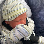 Lyric joined the competition — help win amazing prizes! newborn, baby, car_seat, hat, mittens, striped_clothing, infant, seatbelt, sleeping, cute, child, baby_clothes, safety, indoors, closeup, person, resting, blue, white, patterned