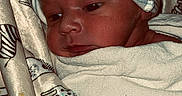Lyric is registered to the contest to win money with this photo: newborn, baby, infant, blanket, hat, face, sleepwear, patterned_fabric, animal_print, wrapped, cozy, closeup, portrait, baby_clothing, soft_texture, resting, cute, indoors, child, young