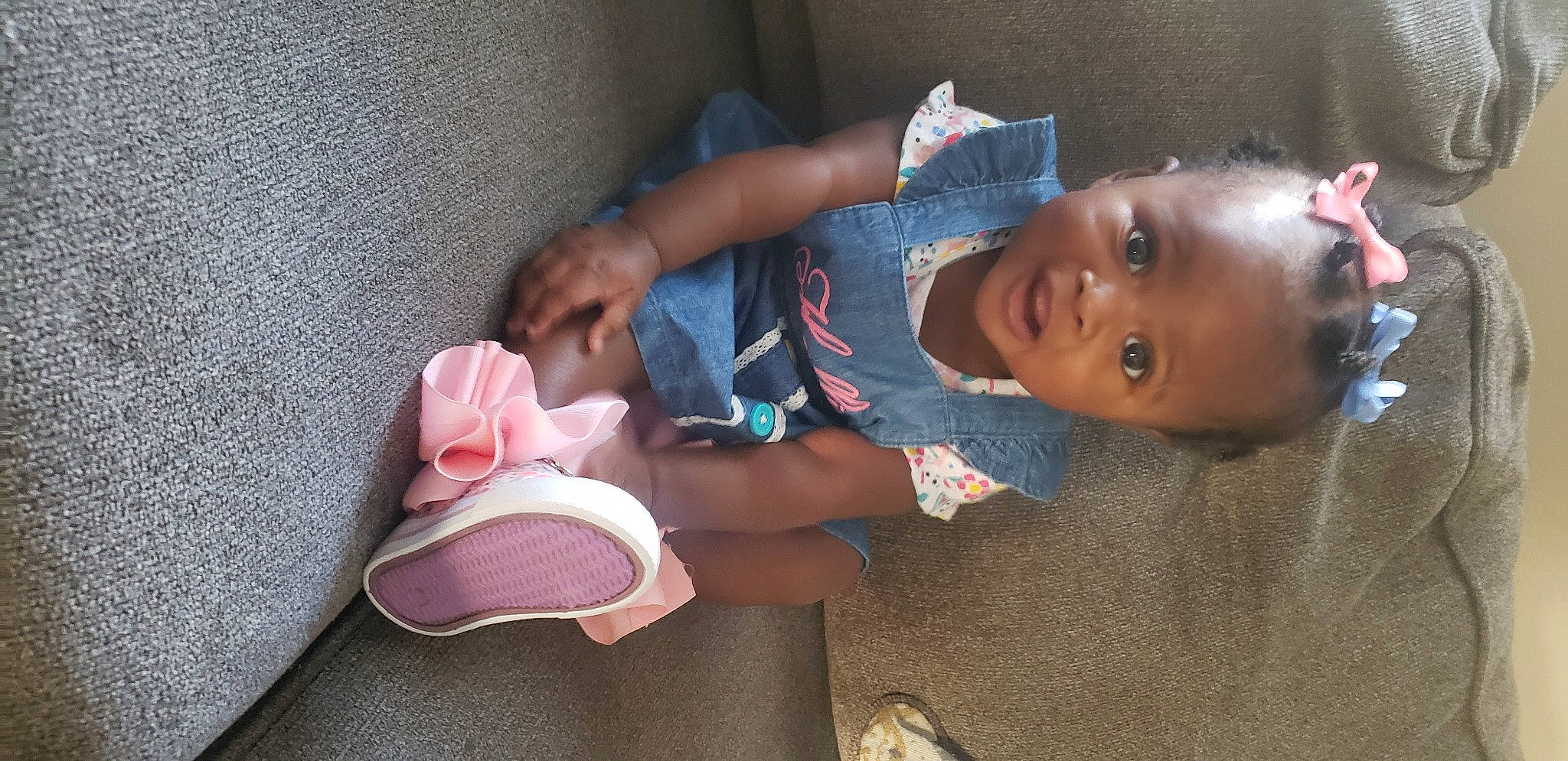 Hallie is registered to the contest to win money with this photo: baby, baby_products, baby_toddler_clothing, carmine, cheek, child, comfort, elbow, finger, hat, headgear, human_leg, leg, mouth, person, sitting, skin, smile, sock, textile