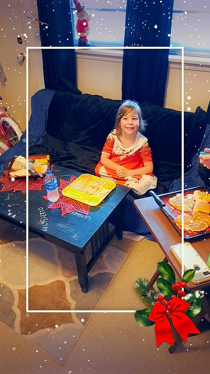 Faelynn is registered to the contest to win money with this photo: coffee_table, comfort, couch, electric_blue, event, flooring, food, fun, indoor_games_and_sports, interior_design, joy, leisure, lighting, living_room, orange, person, recreation, rectangle, room, sitting