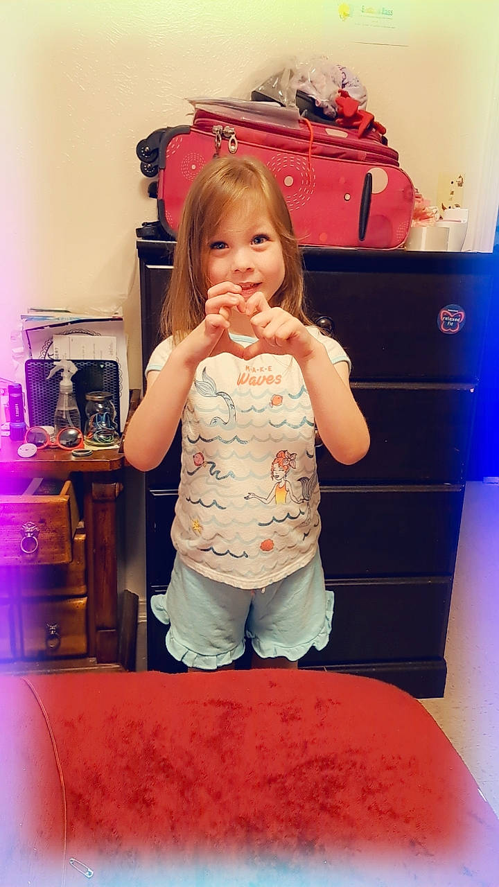 Faelynn is registered to the contest to win money with this photo: bag, cabinetry, child, drawer, flooring, fun, hair, hairstyle, happy, joint, magenta, person, pink, red, room, shoulder, sitting, smile, standing, t_shirt