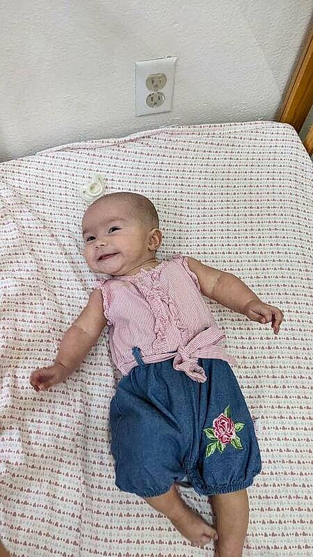 Amara joined the competition — help win amazing prizes! baby, baby_toddler_clothing, barefoot, bedding, child, comfort, day_dress, flooring, happy, human_leg, joy, linens, magenta, pattern, person, sitting, skin, sleeve, smile, t_shirt