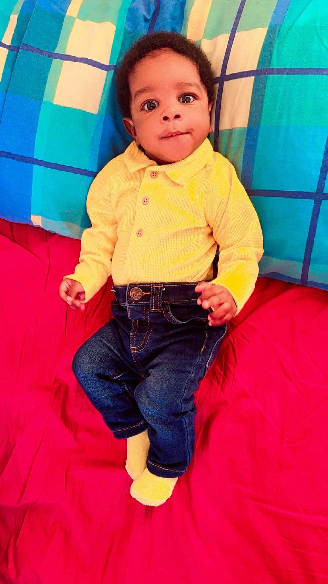 Nolan is registered to the contest to win money with this photo: baby, clothing, coat, couch, cushion, face, furniture, head, homedecor, hosiery, indoors, jacket, jeans, pants, person, photography, portrait, shirt, sitting, sock