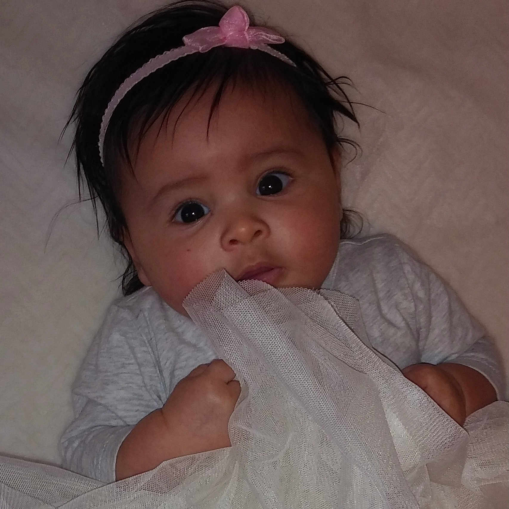 Annalia is registered to the contest to win money with this photo: baby, beauty, cheek, child, chin, eye, face, forehead, hair_accessory, hand, head, headgear, iris, lip, mouth, nose, person, pink, product, skin