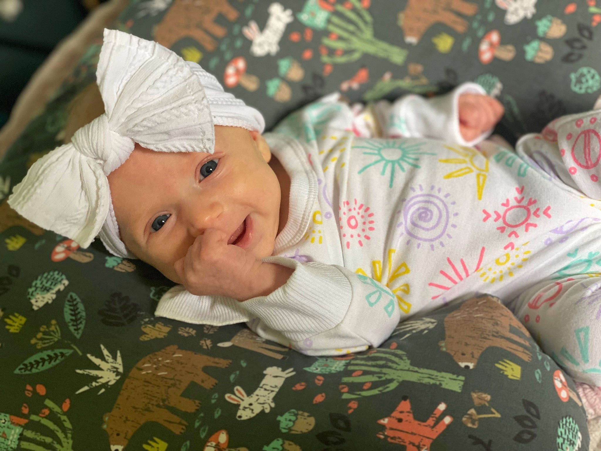 Harlow is registered to the contest to win money with this photo: baby, baby_toddler_clothing, carmine, child, christmas, christmas_eve, event, face, happy, head, headwear, holiday, linens, pattern, person, plant, room, sitting, sleeve, smile