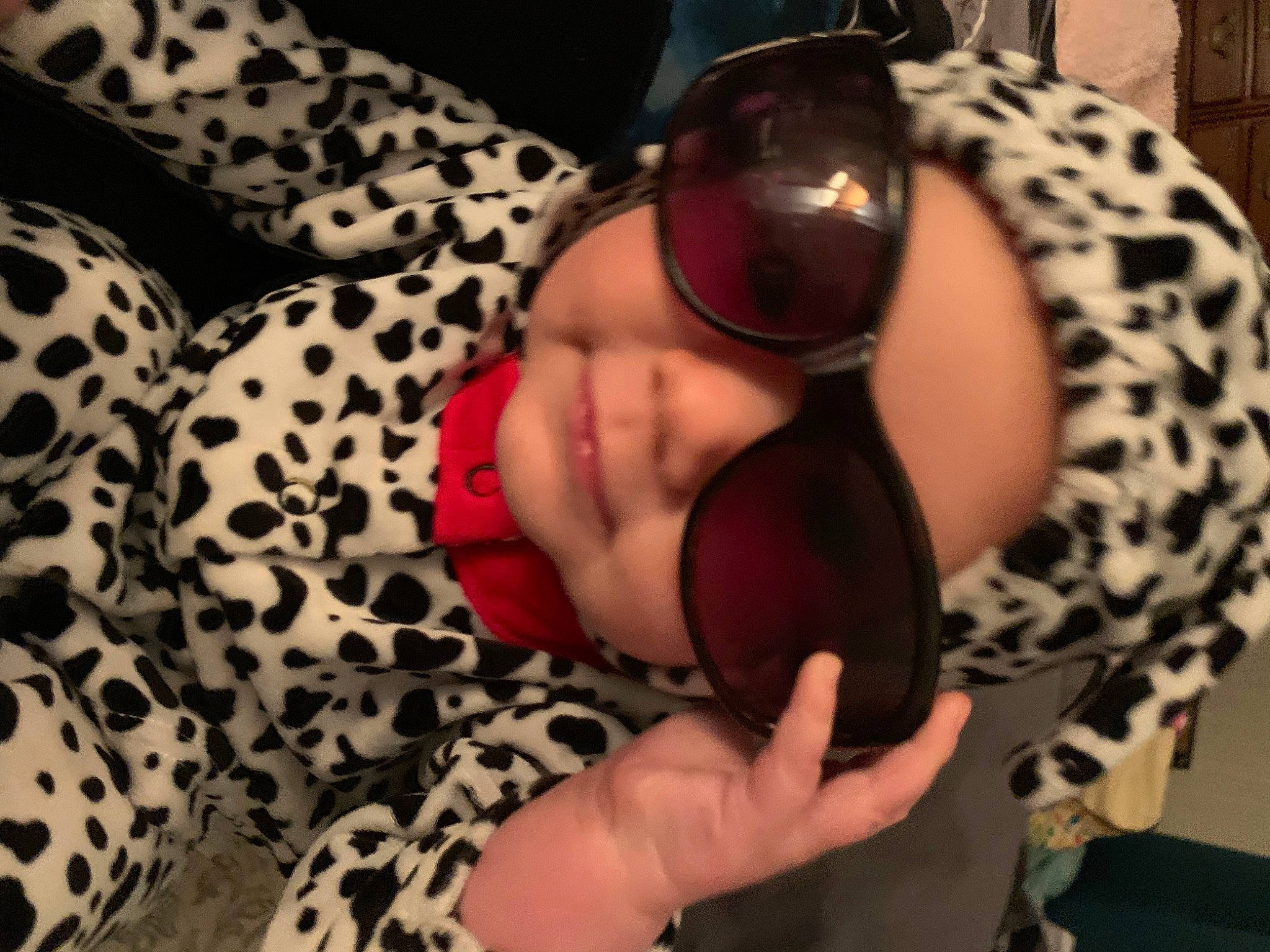 Tara joined the competition — help win amazing prizes! baby, baby_toddler_clothing, child, comfort, ear, eyewear, facial_expression, finger, goggles, hand, headwear, leg, mammal, mouth, nail, pattern, person, skin, sunglasses, thigh