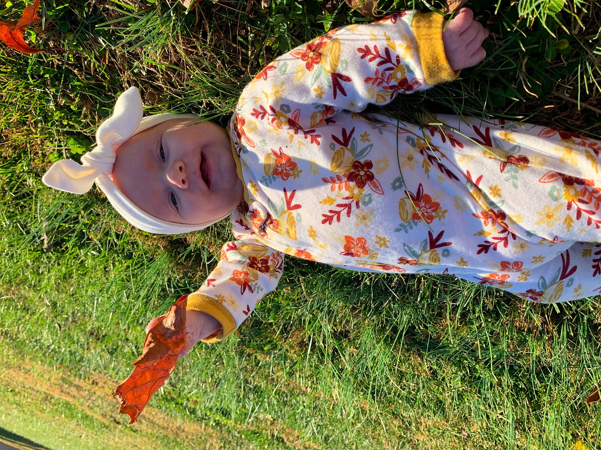 Tara joined the competition — help win amazing prizes! baby_toddler_clothing, child, doll, dress, fashion_accessory, fawn, grass, grassland, happy, hat, headwear, linens, pattern, peach, people_in_nature, person, plant, recreation, sitting, sleeve