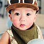 Mateo is registered to the contest to win money with this photo: child, toddler, face, rosy_cheeks, brown_cap, white_sunglasses, bib, patterned_clothing, wide_eyes, pout, indoor, closeup, person, cute, baby, fashion, headwear, expression, soft_lighting, portrait