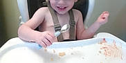 Odin joined the competition — help win amazing prizes! toddler, high_chair, spoon, food, messy, smile, child, meal_time, plate, face, hair, indoor, person, happy, seat, tray, crumbs, baby, skin, clothing_straps