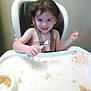 toddler, high_chair, spoon, food, messy, smile, child, meal_time, plate, face, hair, indoor, person, happy, seat, tray, crumbs, baby, skin, clothing_straps