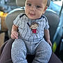 baby, infant, child, face, eyes, clothing, monkey, shirt, pants, socks, drool, person, portrait, indoor, car, seat, lap, cute, curious, cozy