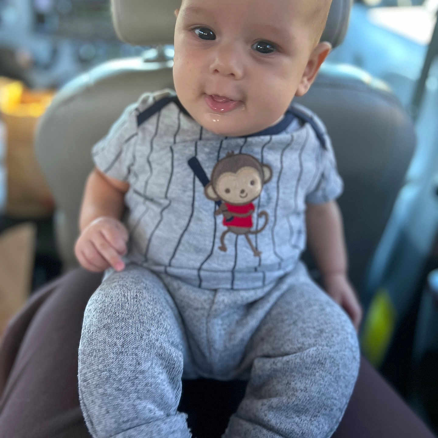 Shadoe joined the competition — help win amazing prizes! baby, car, child, clothing, cozy, curious, cute, drool, eyes, face, indoor, infant, lap, monkey, pants, person, portrait, seat, shirt, socks