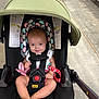 baby, stroller, child, smiling, infant, seatbelt, toy, canopy, padded, floor, person, walking, footwear, clothing, colorful, cute, indoors, black, pink, red