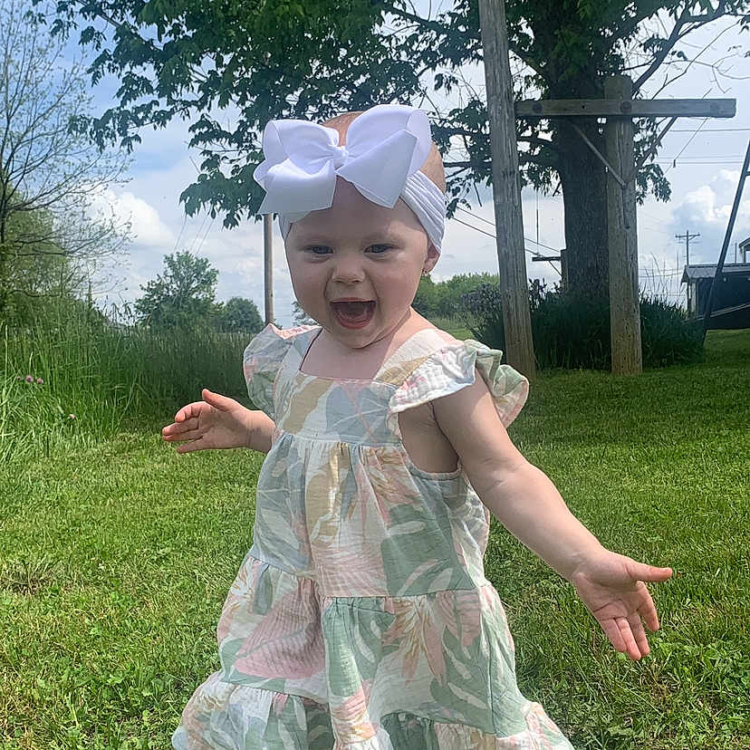Sawyer is registered to the contest to win money with this photo: backyard, clothing, costume, dress, face, grass, green, hat, head, nature, outdoors, park, person, photography, plant, portrait, summer, tree, vegetation, yard