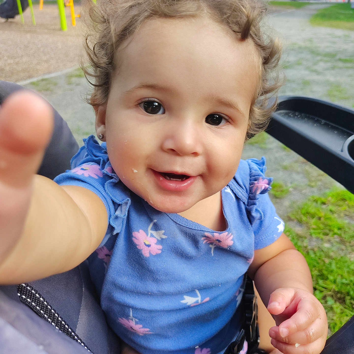 Soliany joined the competition — help win amazing prizes! baby, blue_dress, child, curly_hair, cute, daylight, grass, happy, nature, outdoor, park, person, playground, reaching_hand, seat, smiling, stroller, summer, swing_set, toddler