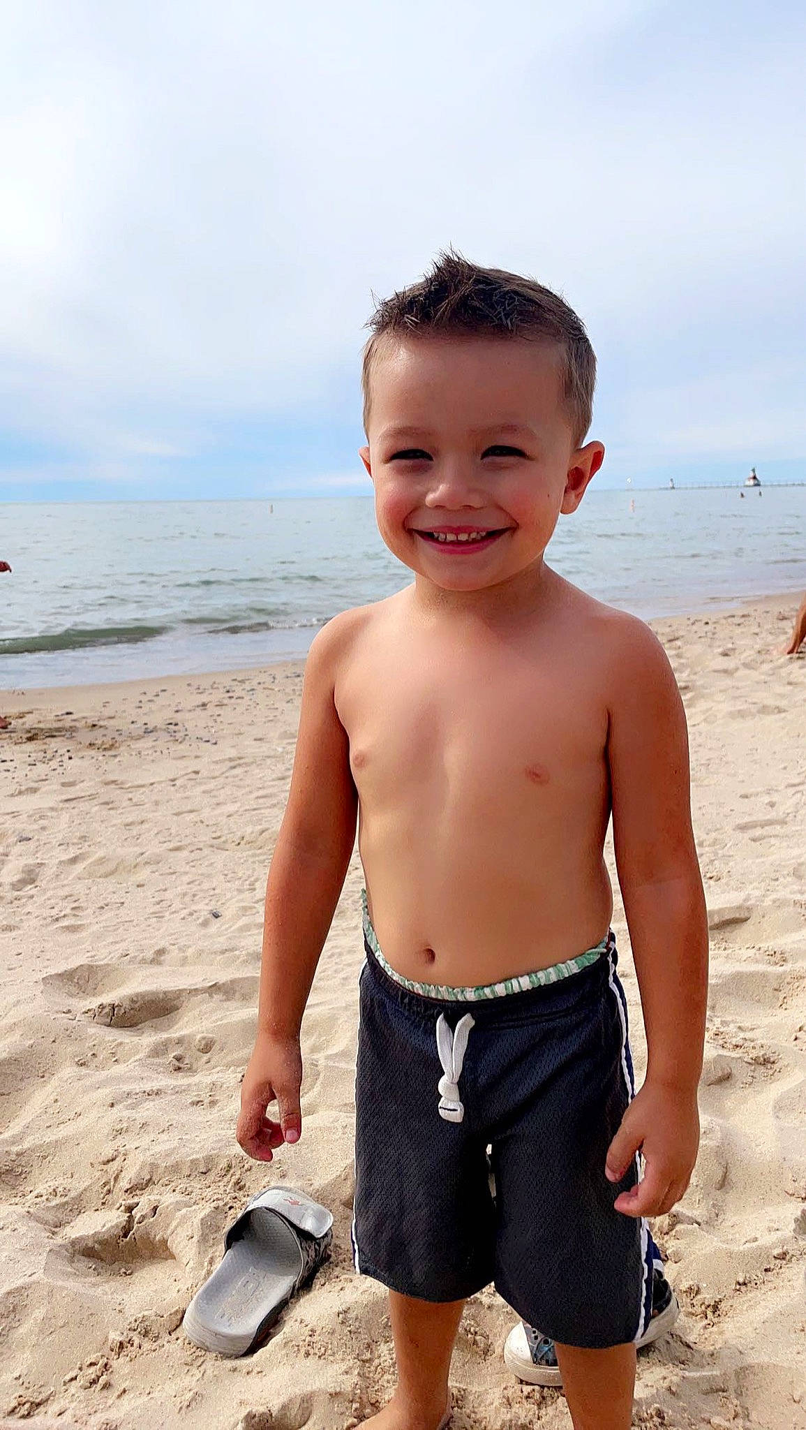 Bowen joined the competition — help win amazing prizes! barechested, beach, bermuda_shorts, board_short, chest, child, cloud, fun, happy, joy, people_on_beach, person, sand, shorts, sky, smile, summer, swimwear, toddler, trunk