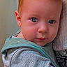 baby, infant, child, portrait, face, eyes, blue_eyes, red_hair, sitting, being_held, adult, clothing, gray_clothing, teal_clothing, indoor, close_up, looking_at_camera, serious_expression, soft_background, family
