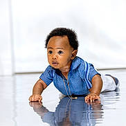Israel joined the competition — help win amazing prizes! baby, child, crawling, blue_shirt, reflection, curly_hair, indoors, floor, suspenders, necklace, wide_eyes, cute, portrait, infant, young_child, curiosity, light_background, studio, expression, hands