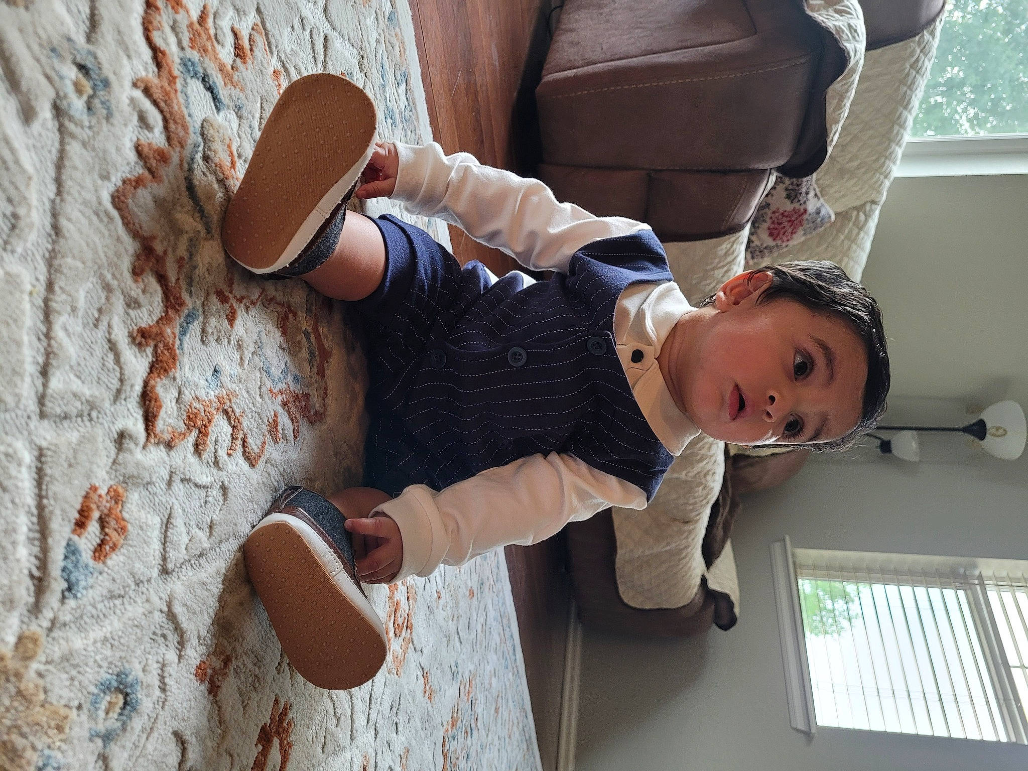 Armaan is registered to the contest to win money with this photo: baby, baby_toddler_clothing, brick, child, elbow, flooring, foot, fun, hat, headgear, human_leg, knee, leisure, person, sitting, sock, street_fashion, sun_hat, surprise, thigh