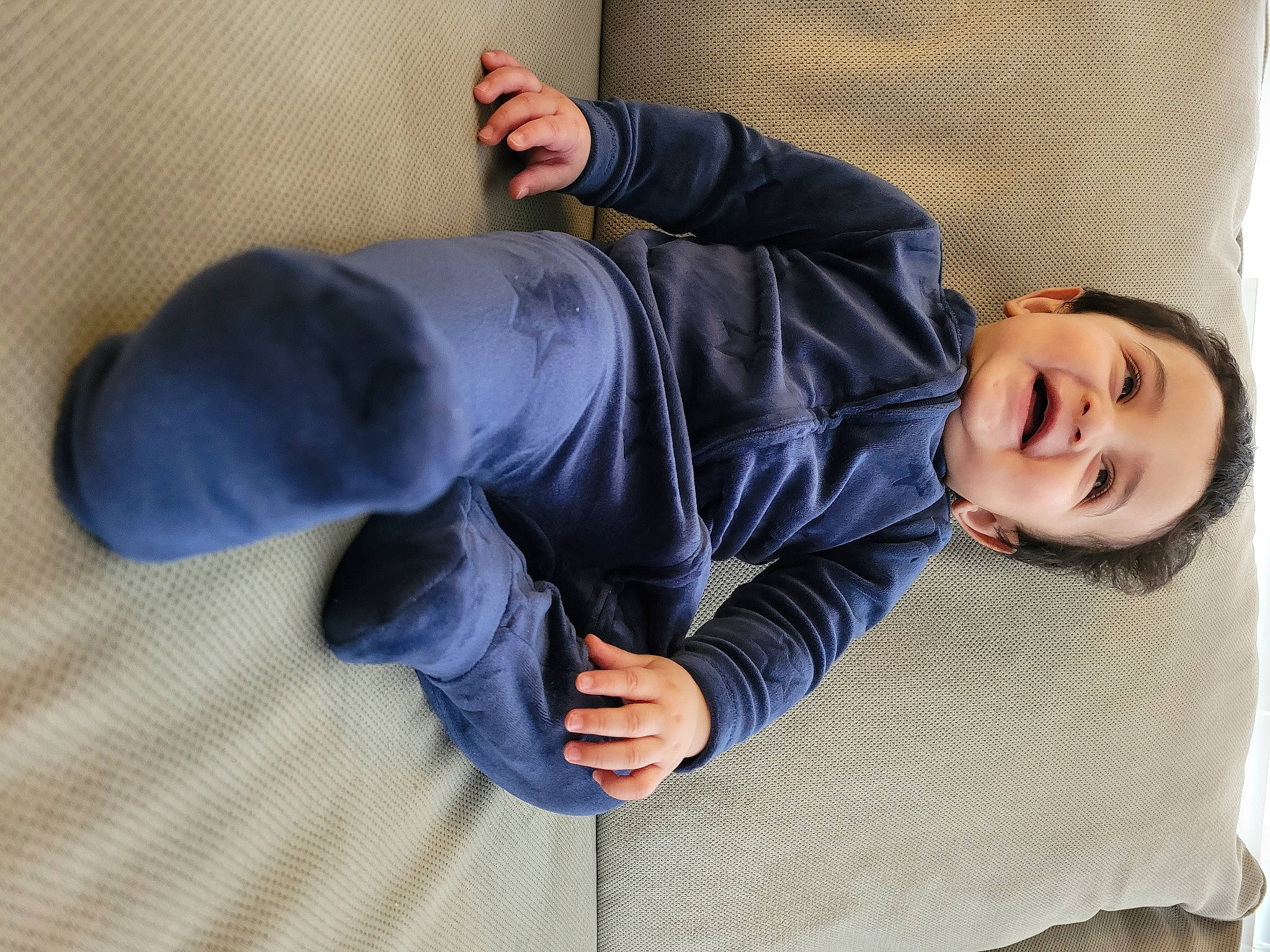 Armaan is registered to the contest to win money with this photo: baby_toddler_clothing, child, collar, comfort, denim, elbow, electric_blue, flooring, foot, human_body, human_leg, jacket, joint, knee, person, sitting, sleeve, smile, street_fashion, toddler