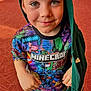 child, boy, minecraft, colorful_shirt, hoodie, green_hoodie, standing, white_shoes, smiling, indoor, carpet, patterned_floor, casual_clothing, short_hair, young_child, portrait, looking_up, happy, bright_eyes, freckles