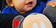 Enzo a rejoint le concours — aidez-le/la à gagner de superbes lots ! baby, child, smile, blue_jacket, stroller, plush_toy, mickey_mouse, toy, happy, face, hand, outerwear, blanket, cushion, person, cute, infant, indoors, portrait, closeup