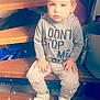 toddler, child, stairs, wood, hoodie, sitting, indoors, casual_clothing, shoes, expressionless, sparkle_filter, hair, face, hands, light, bag, background, gray_clothing, young_child, person