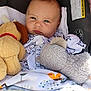 Christopher James joined the competition — help win amazing prizes! baby, infant, car_seat, blanket, plush_toy, stuffed_animal, face, child, cute, indoors, clothing, warning_label, close_up, portrait, expression, resting, soft_toy, comfort, young_child, seat