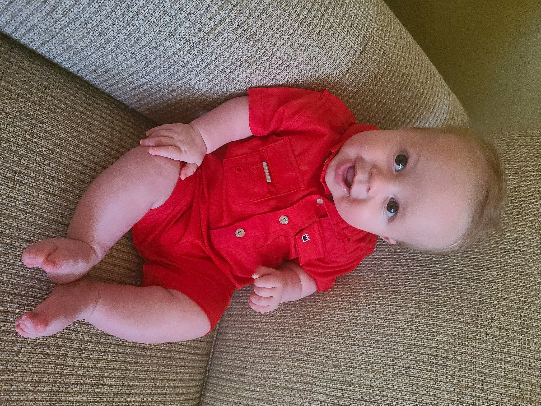 Randy is registered to the contest to win money with this photo: baby, baby_toddler_clothing, cheek, child, comfort, eye, finger, floor, flooring, foot, head, human_body, nose, person, pink, skin, sleeve, smile, textile, toddler