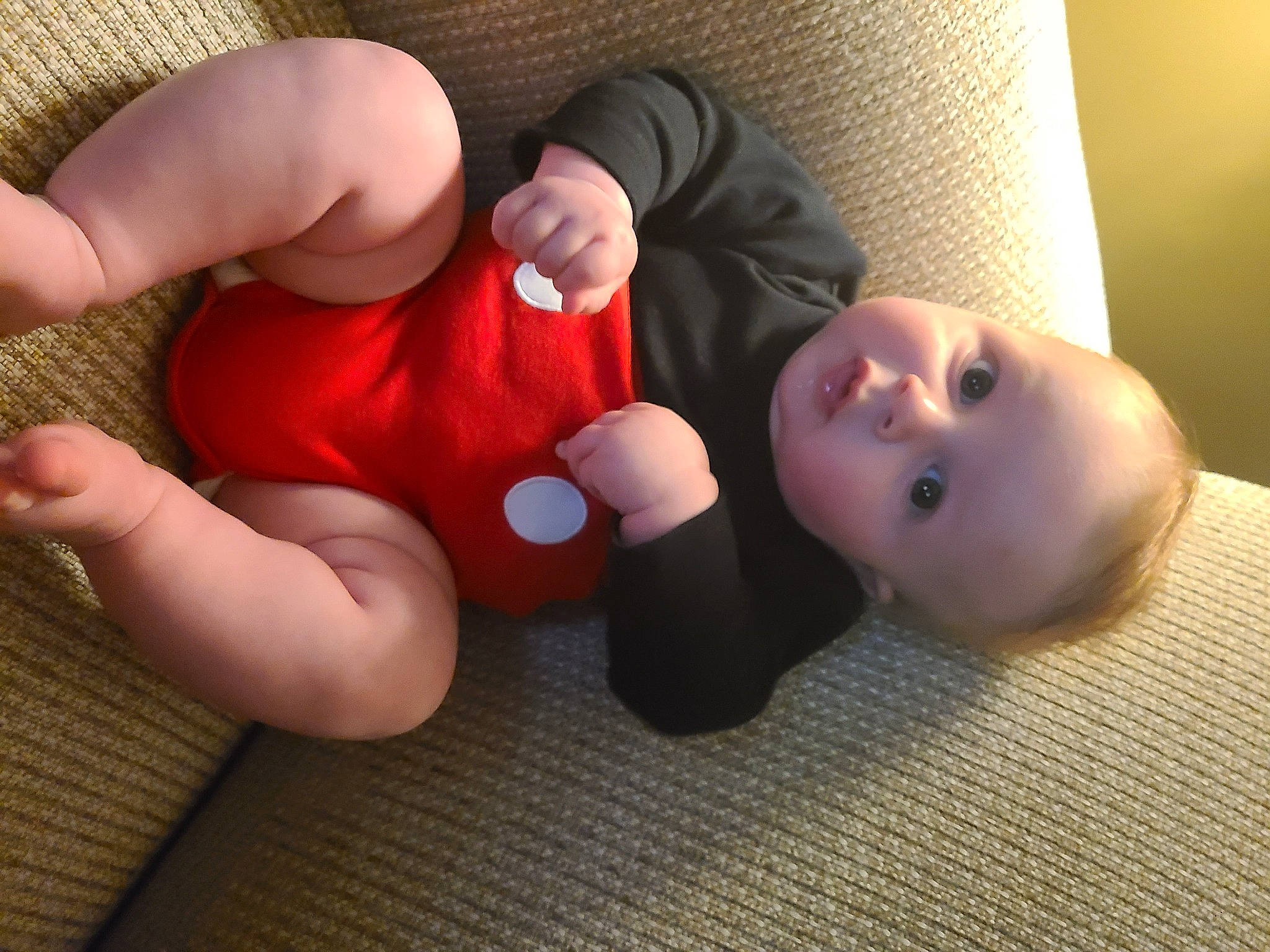 Randy is registered to the contest to win money with this photo: baby, baby_products, baby_toddler_clothing, child, comfort, facial_expression, finger, flooring, foot, gesture, hand, hardwood, joint, mouth, nail, person, skin, thumb, toddler, toy