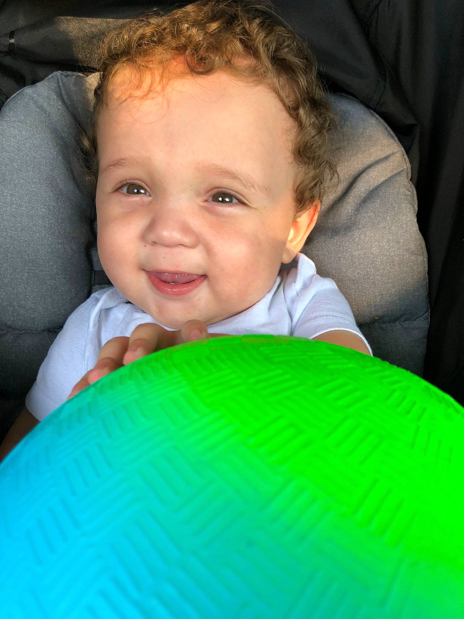 Javier joined the competition — help win amazing prizes! baby, cheek, child, chin, eye, face, facial_expression, forehead, fun, green, head, mouth, nose, person, play, sitting, skin, smile, toddler