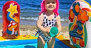 Mia is registered to the contest to win money with this photo: beach, bucket, child, family_vacation, happy, horizon, inflatable_pool, ocean, pink_hat, play, sand, smile, standing, summer, sunny, swimsuit, toddler, toy, water, waves