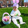 Mia is registered to the contest to win money with this photo: buildings, bunny_ears, child, easter_basket, egg, grass, greenery, hat, lawn, outdoor, park, people, plush, shoes, smile, sunny, toddler, toy, trees, white_costume