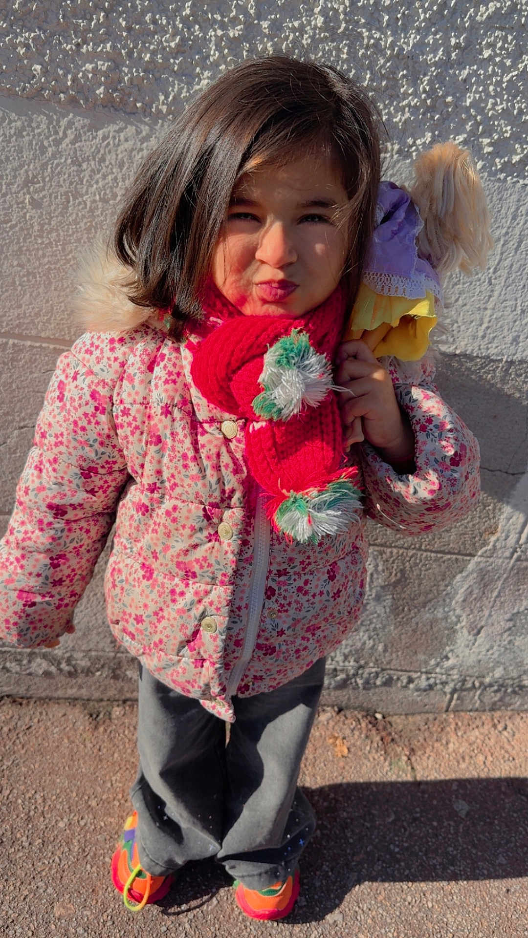 Anehyra a rejoint le concours — aidez-le/la à gagner de superbes lots ! child, girl, scarf, jacket, doll, outdoor, wall, shadow, pavement, colorful_shoes, winter_clothing, cute, portrait, standing, playful, sunlight, expression, hair, person, toy