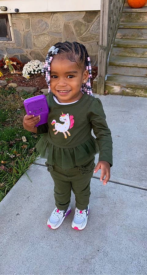 Rayne is registered to the contest to win money with this photo: baby_toddler_clothing, costume, face, fashion_accessory, flower, footwear, formal_wear, fun, grass, happy, head, jewellery, joy, necklace, person, pink, plant, purple, sleeve, smile