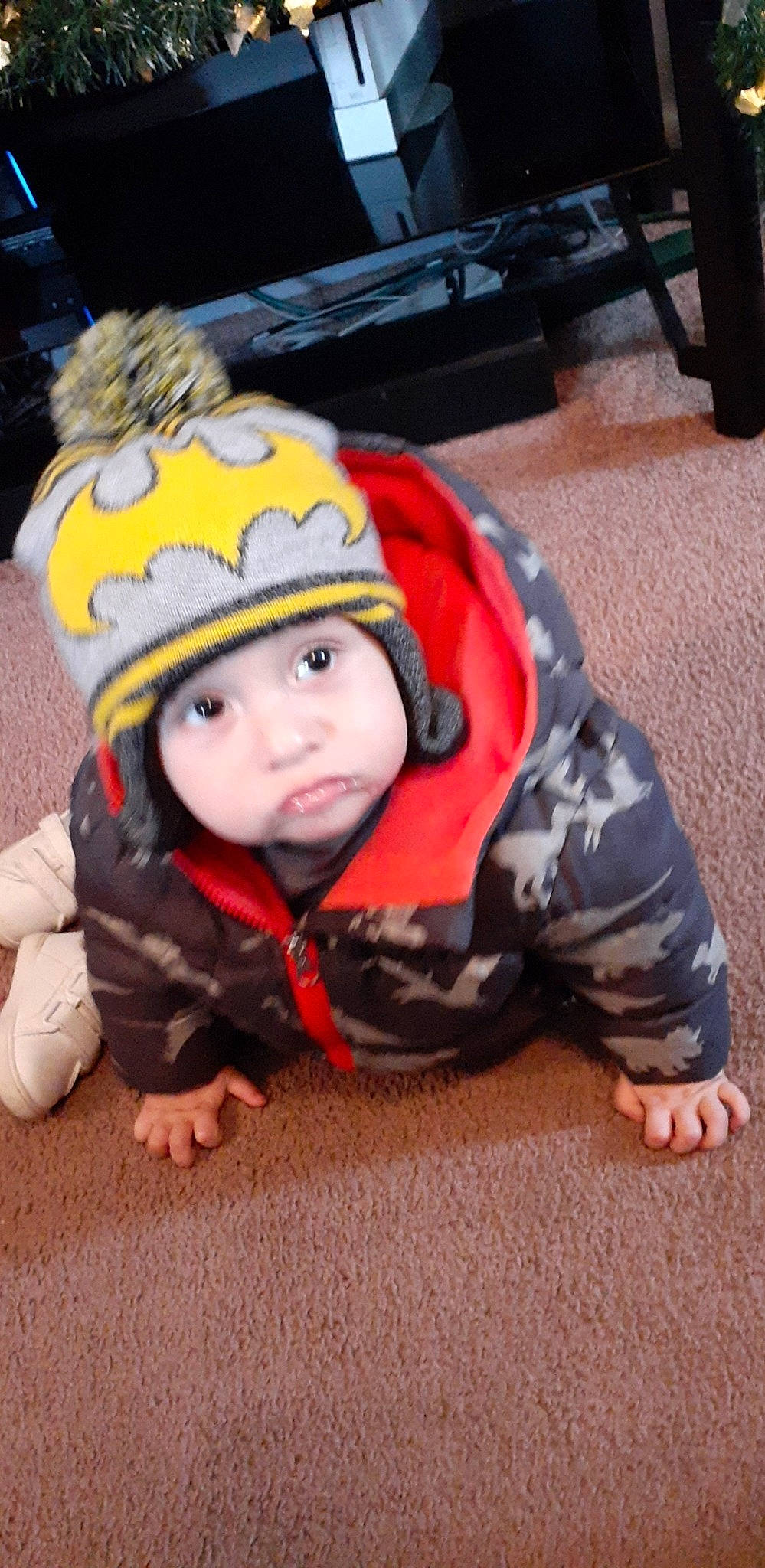 Manuel joined the competition — help win amazing prizes! asphalt, audio_equipment, baby, beanie, cap, child, eye, fashion_accessory, flooring, fun, fur, grass, headwear, knit_cap, person, personal_protective_equipment, road_surface, sitting, toddler, winter