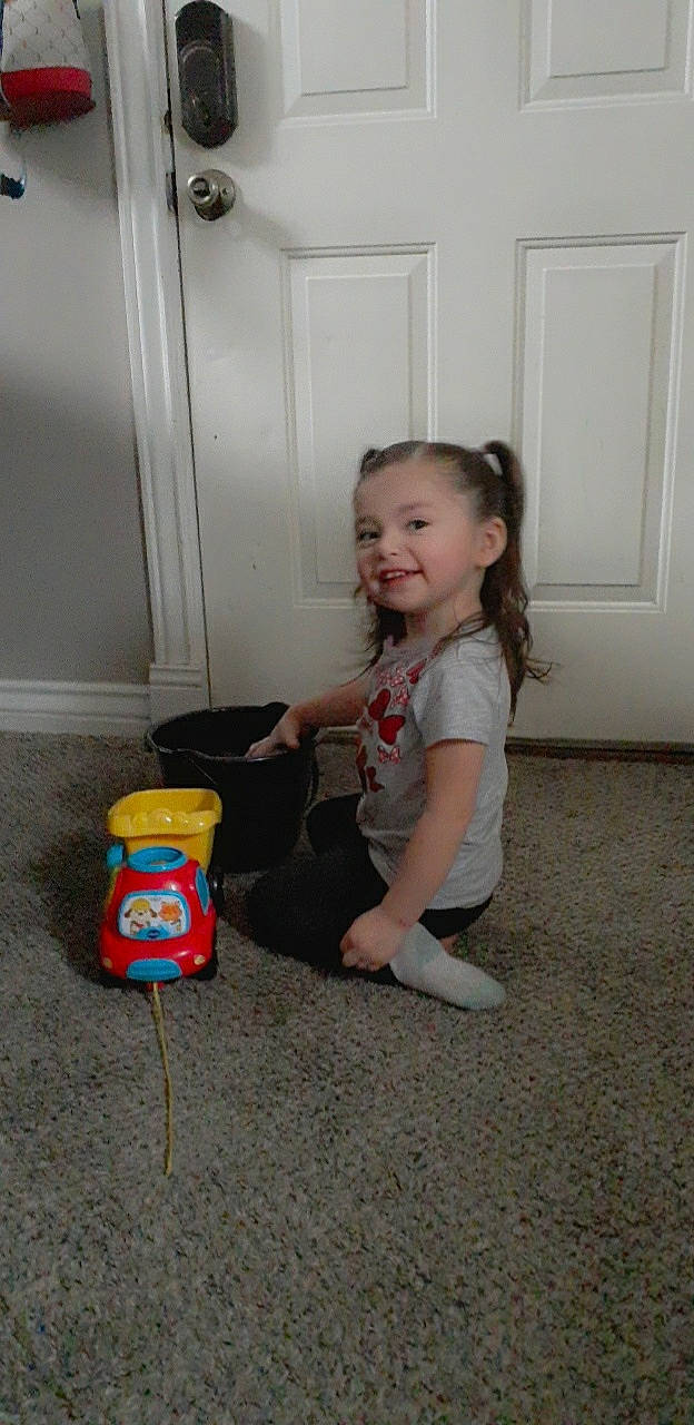 Ezralina is registered to the contest to win money with this photo: baby_toddler_clothing, child, door, floor, flooring, fun, happy, hardwood, home_door, joy, person, plastic, play, room, sitting, smile, standing, toddler, toy, toy_vehicle