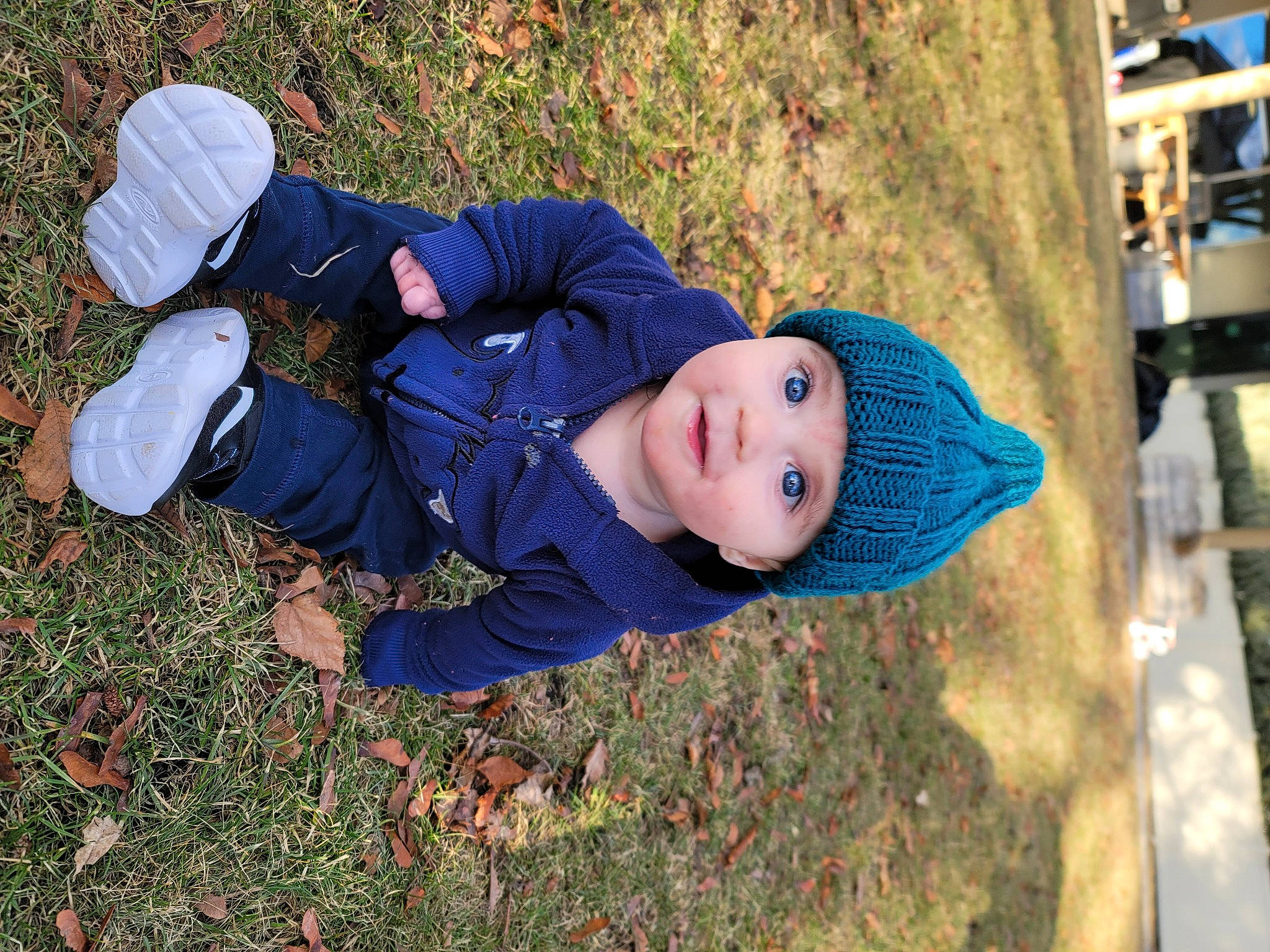 Aries joined the competition — help win amazing prizes! autumn, baby, baby_toddler_clothing, child, electric_blue, fun, grass, happy, hat, headwear, jacket, leisure, people_in_nature, person, plant, recreation, sitting, smile, toddler, tree