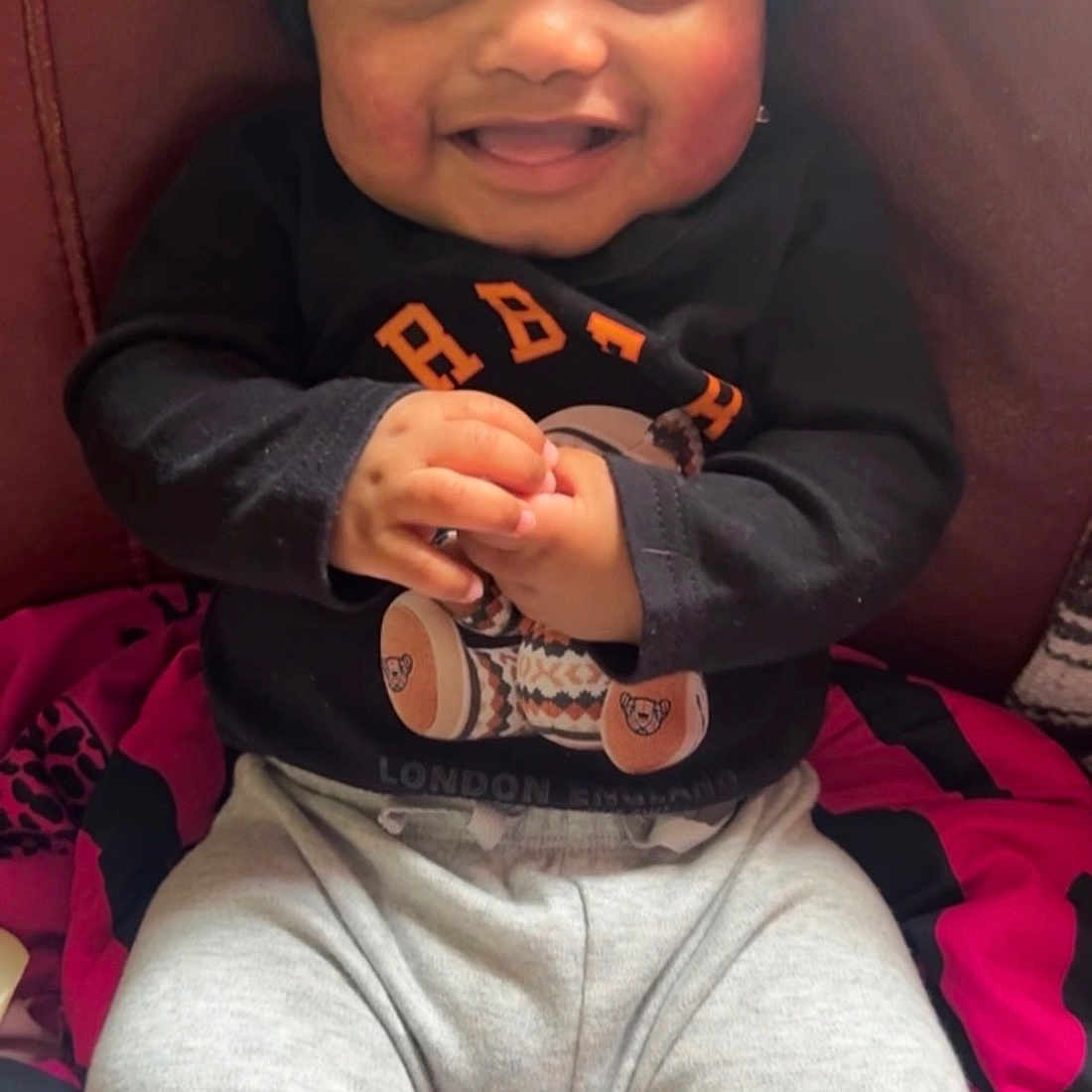 Kevion joined the competition — help win amazing prizes! baby, smiling, child, portrait, clothing, hat, sitting, happy, indoor, cute, person, face, cozy, blanket, pants, long_sleeve, infant, comfort, joy, warm