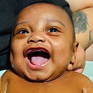 Kevion is registered to the contest to win money with this photo: baby, laughing, smiling, face, skin, child, person, tattoo, arm, hand, expression, joy, happy, closeup, portrait, infant, cute, human, emotion, cheerful