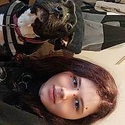 Ruby is registered to the contest to win money with this photo: dog, person, face, pet, indoor, couch, collar, harness, selfie, playful, relaxed, bed, blanket, brown_hair, brown_eyes, heart_stickers, closeup, portrait, living_room, companion