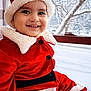 toddler, child, smiling, santa_hat, red_clothing, winter, snow, window, holiday, festive, cute, portrait, indoor, seasonal, happy, baby, fur_trim, buttoned_jacket, face, black_eyes