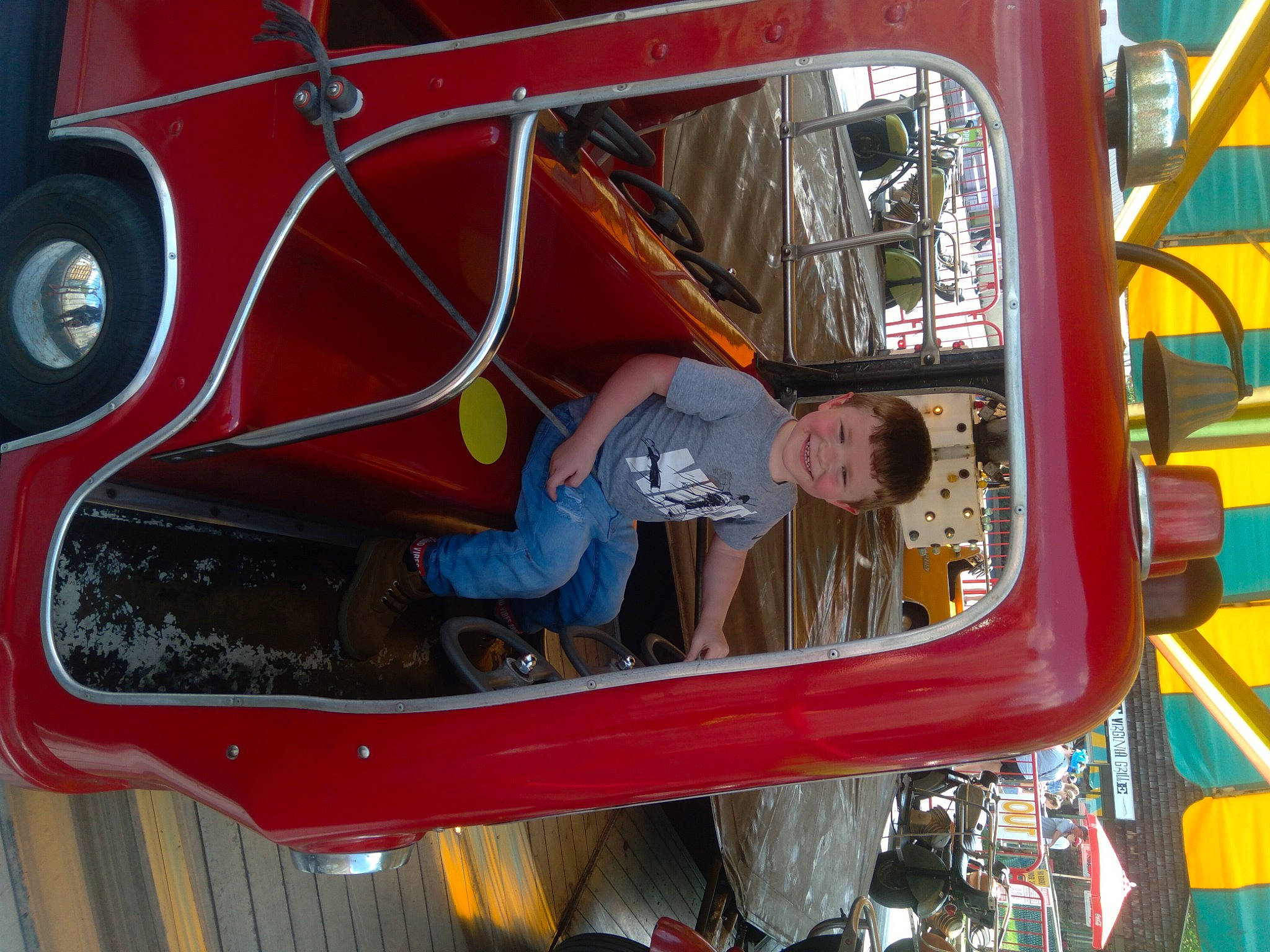 Keith is registered to the contest to win money with this photo: auto_part, automotive_design, automotive_exterior, automotive_lighting, automotive_wheel_system, bumper, engineering, fun, hood, joy, leisure, machine, mode_of_transport, motor_vehicle, person, recreation, red, t_shirt, vehicle, vehicle_door